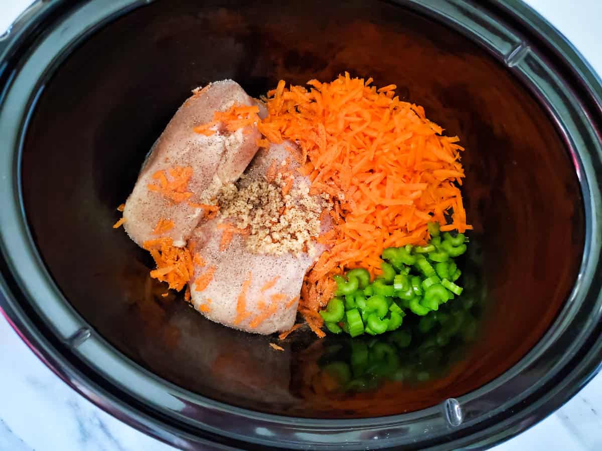 chicken, carrots, celery and seasonings in the slow cooker.