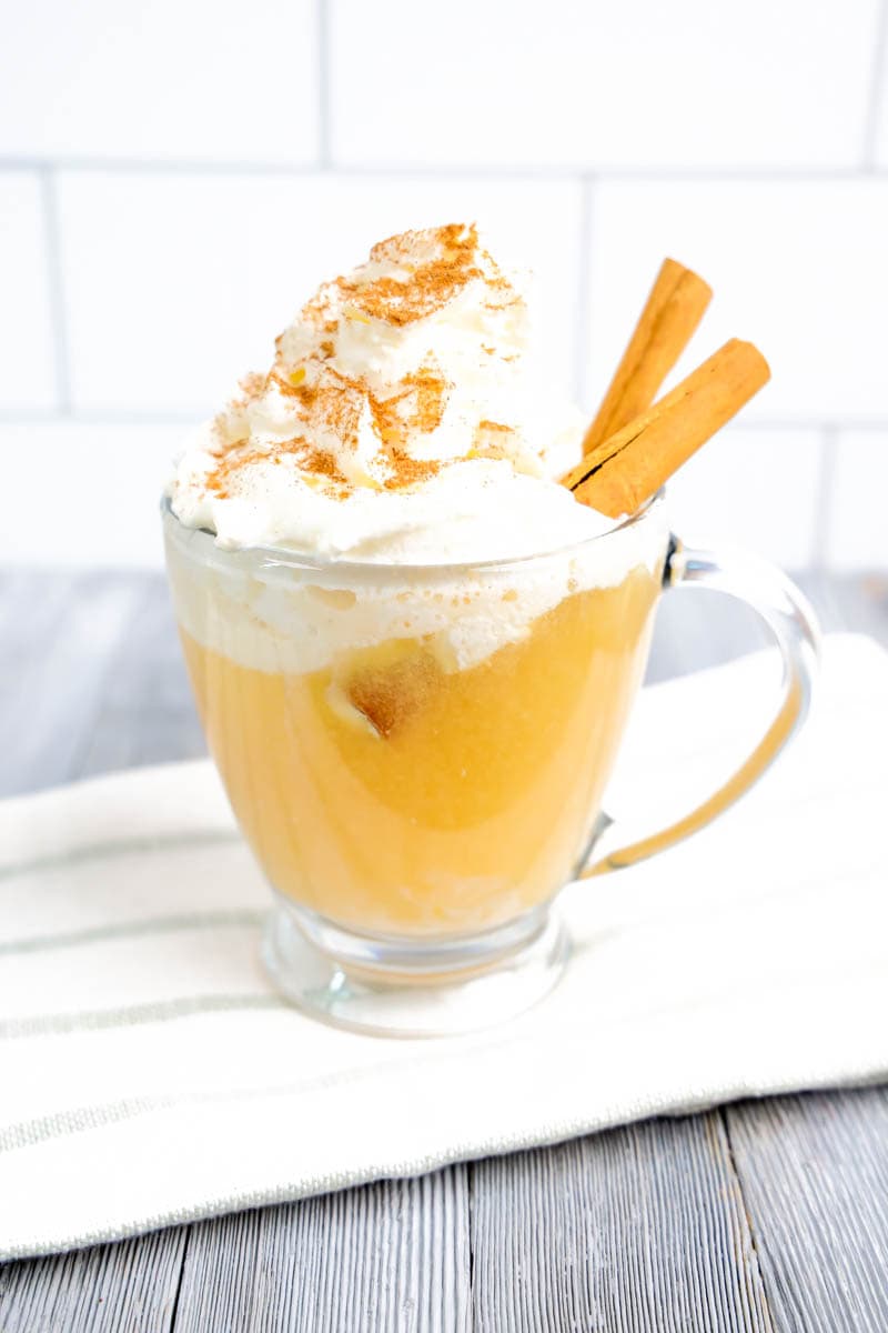 Apple Cider Float on a white towel with gray stripes with gray/white background