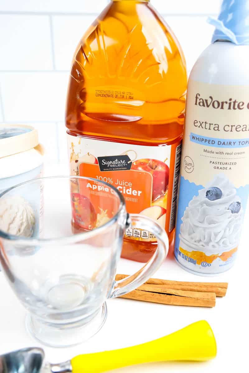 Ice cream box, apple cider, whipped cream, cinnamon sticks with clear cup