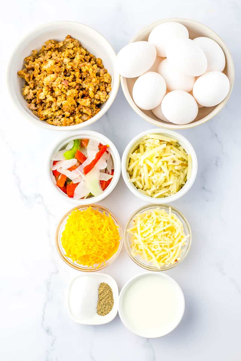 All ingredients in white bowls on white background.
