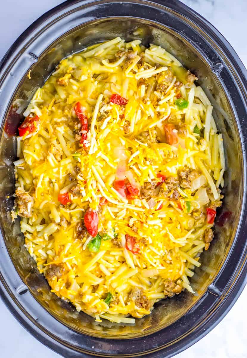 Casserole is layered in the crockpot and is ready to cook.