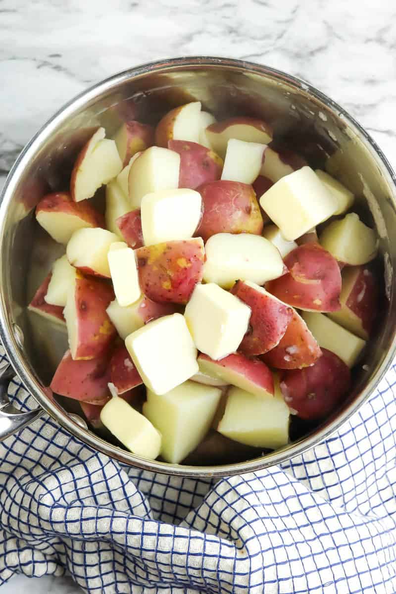Pot with cooked potatoes and water drained.
