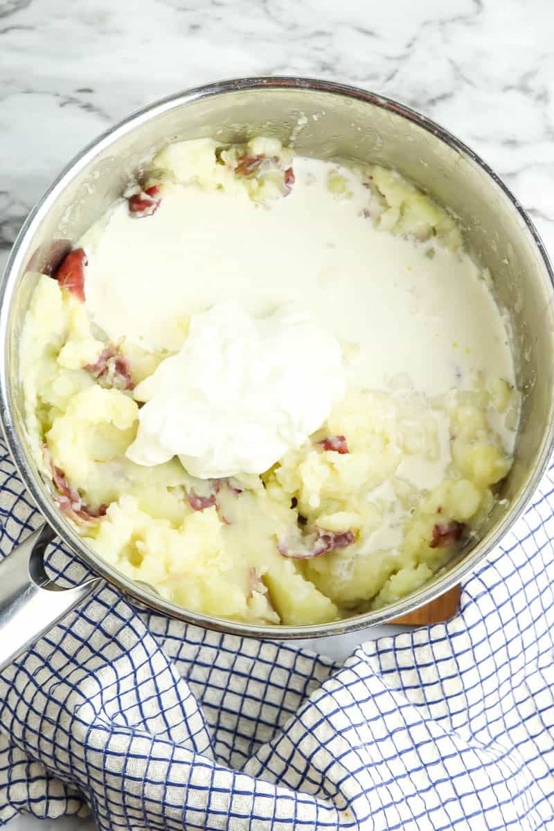 Pot of mashed potatoes with heavy cream and sour cream put in.