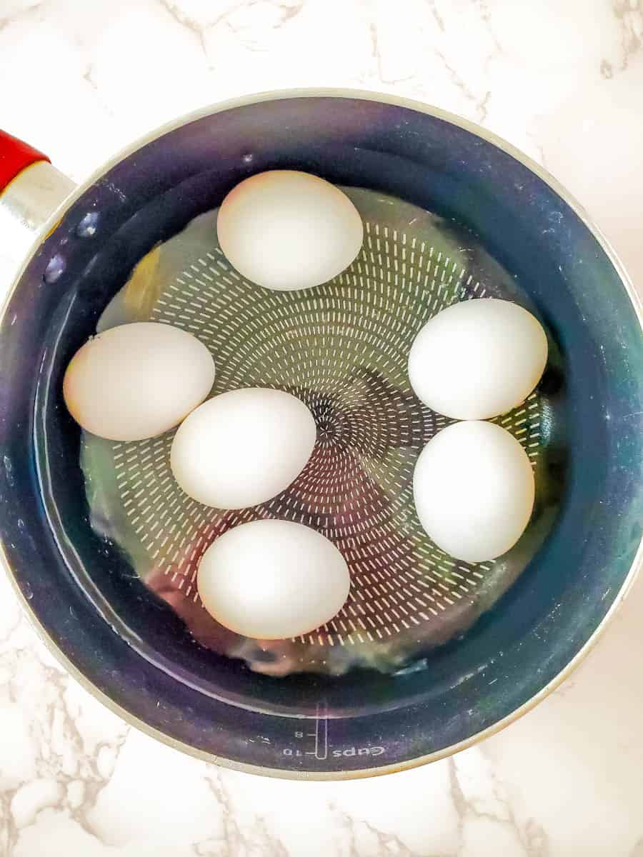 Pot with eggs boiling