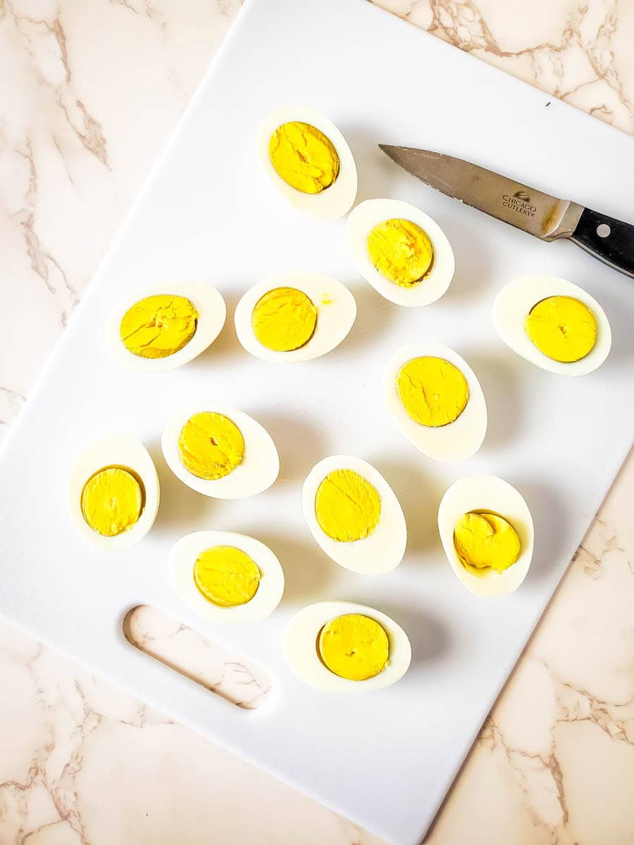 Eggs sliced in half on marble background