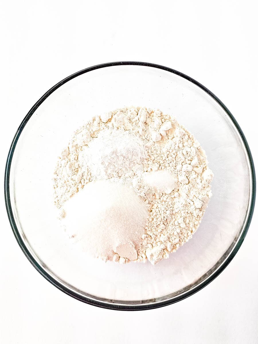 Dry ingredients mixed in clear glass bowl.