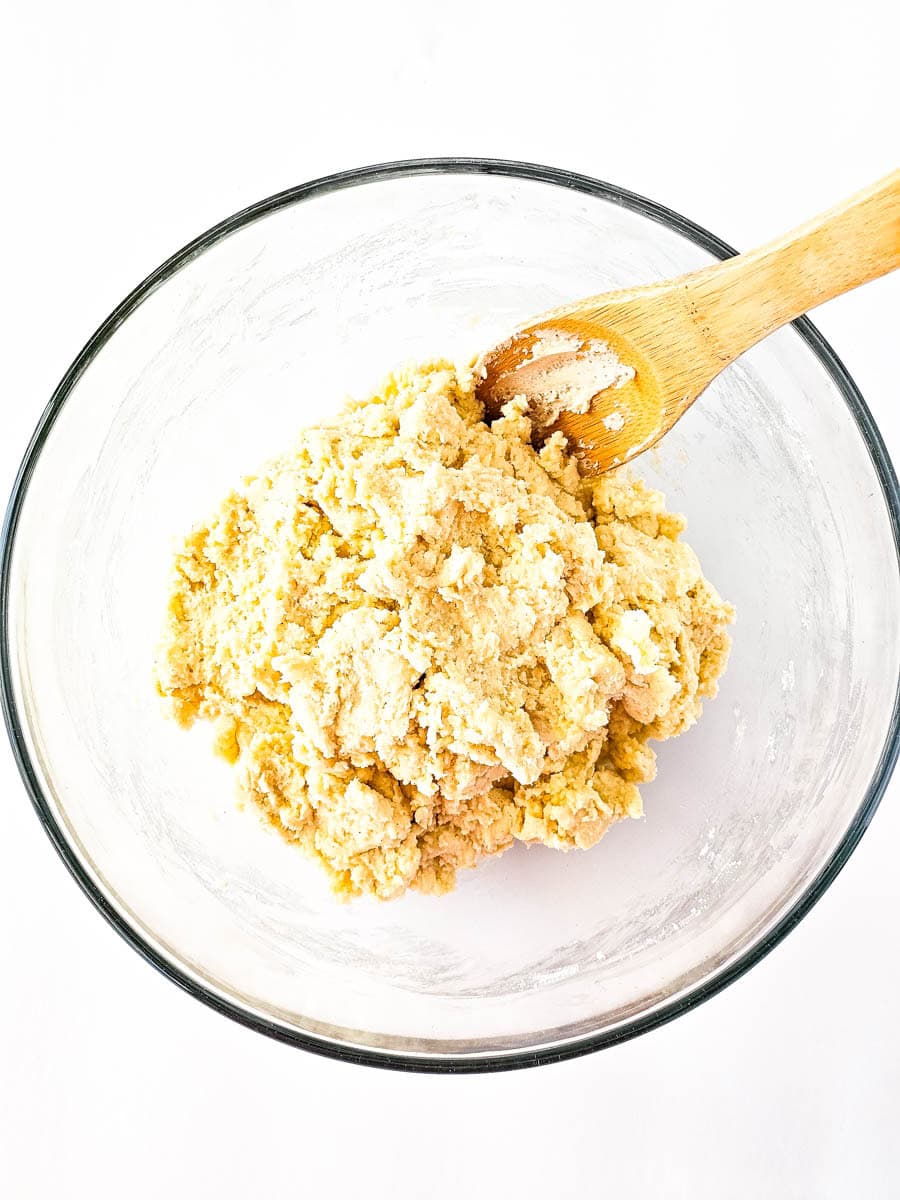 Wet and dry ingredients combined in a clear glass bowl for the shortcakes.
