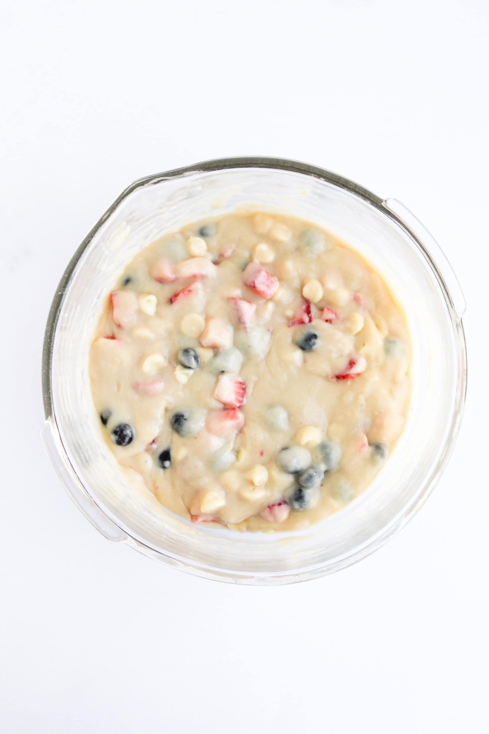 Berries and white chocolate chips mixed into batter
