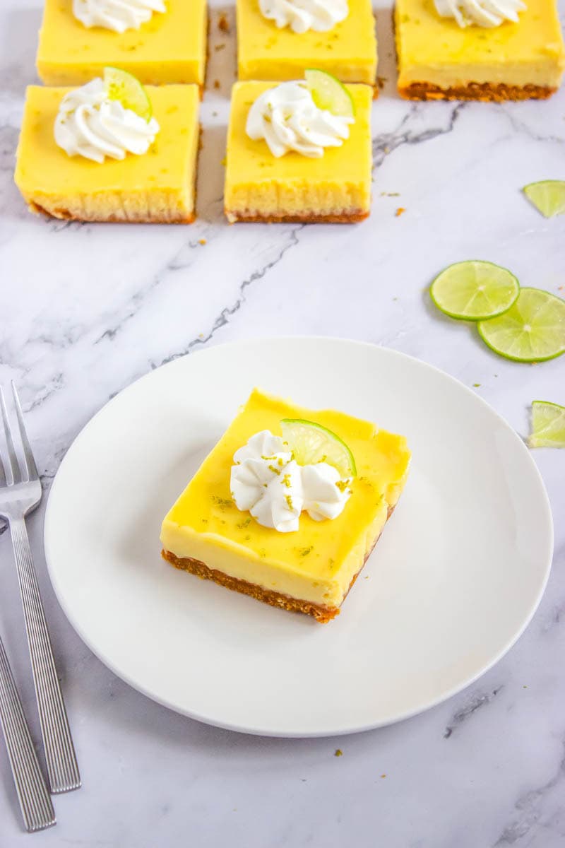 One key lime pie bar on a white plate.