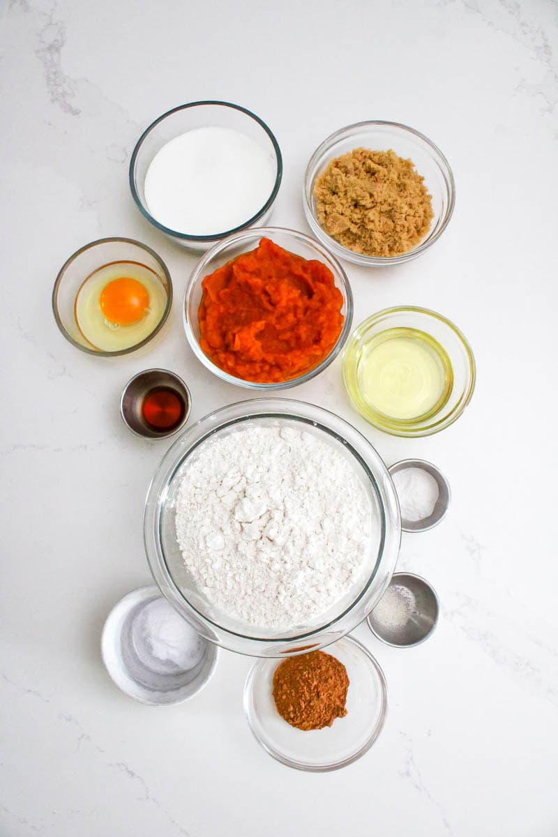 Ingredients for the pumpkin cheesecake cookies on white background.