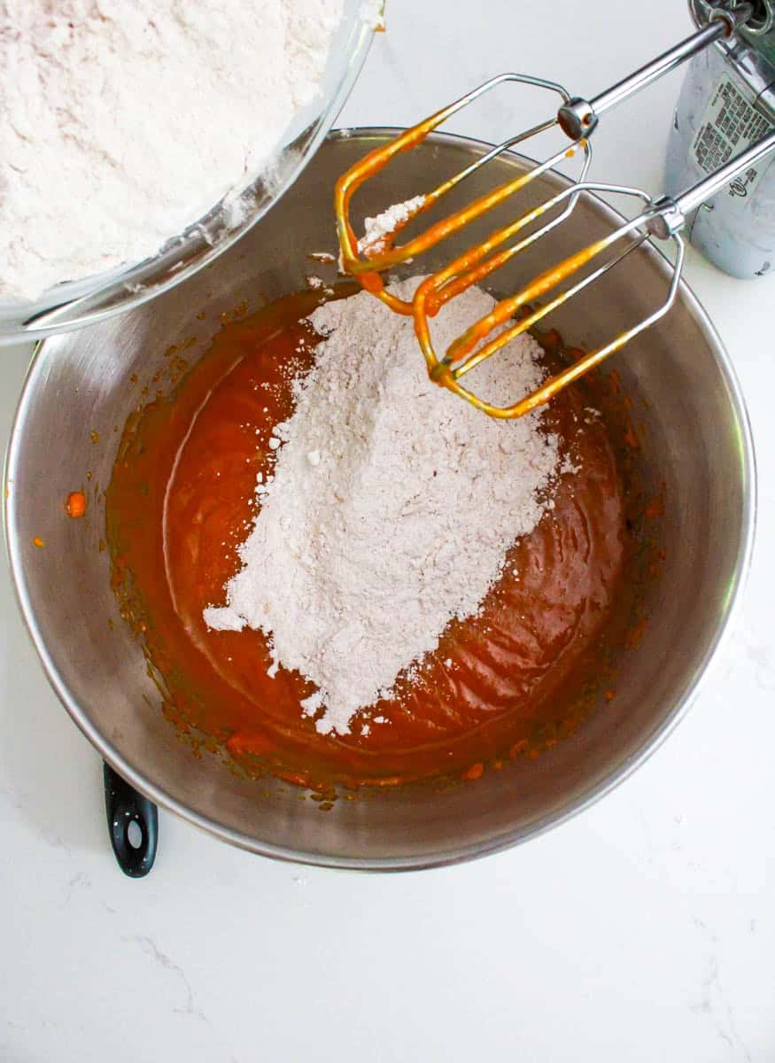 The dry cookies ingredients being mixed and combined with the wet ingredients.