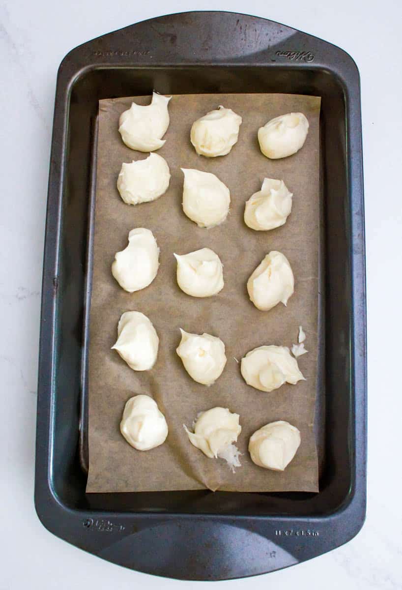 Dollop of cream cheese on a baking sheet.
