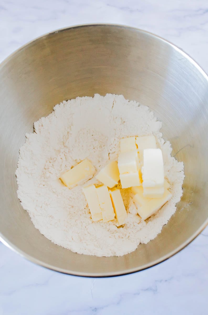 Flour, butter and salt in a metal bowl.