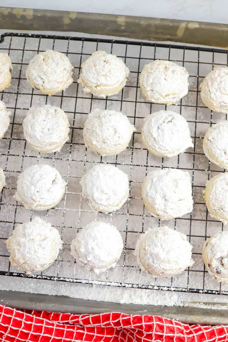 Gluten free chocolate chip snowball cookies on a wire rack.