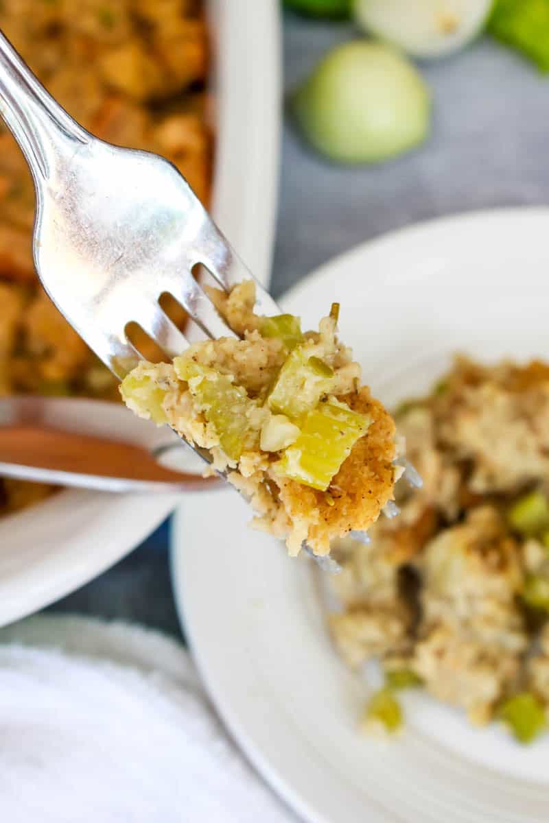 Fork with stuffing on it being lifted from a plate.