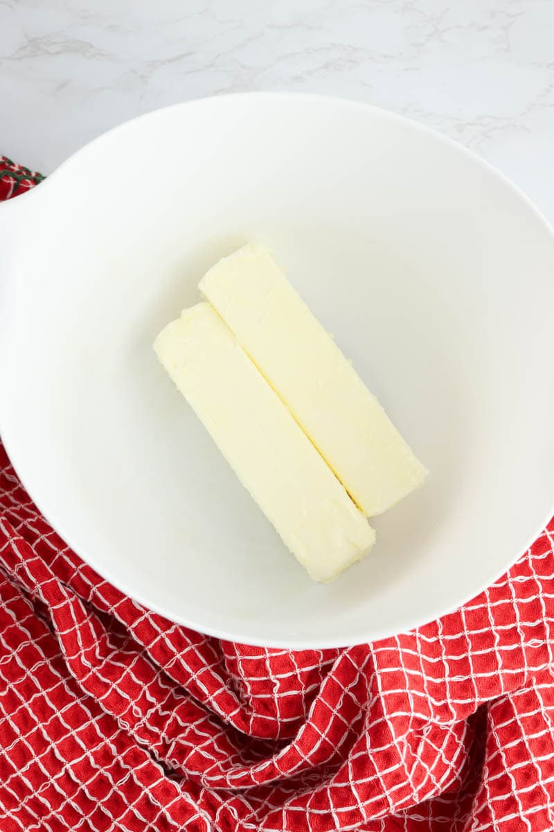 Two sticks of butter in a white bowl