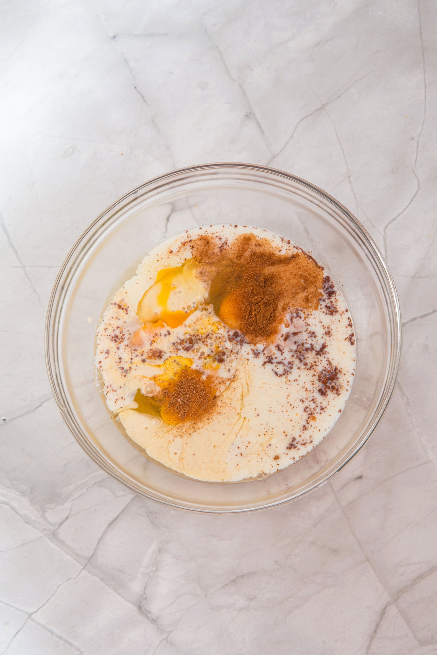 All the liquid ingredients for the eggnog french toast in one bowl mixed up.