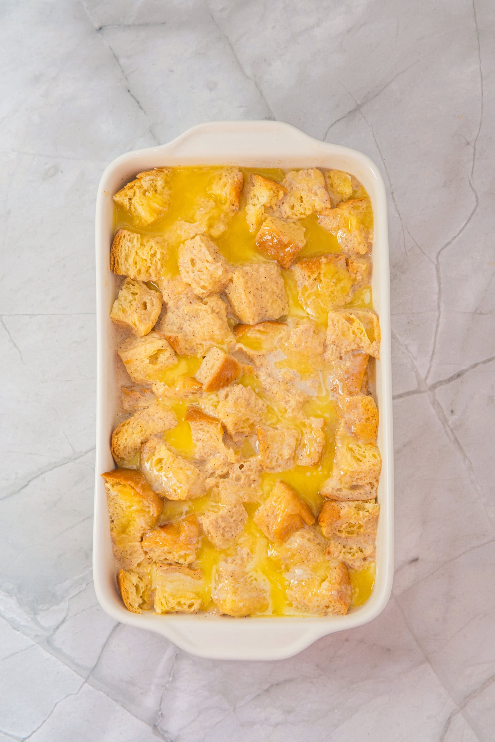 Liquid mixture combined with the gluten free bread in the casserole dish.