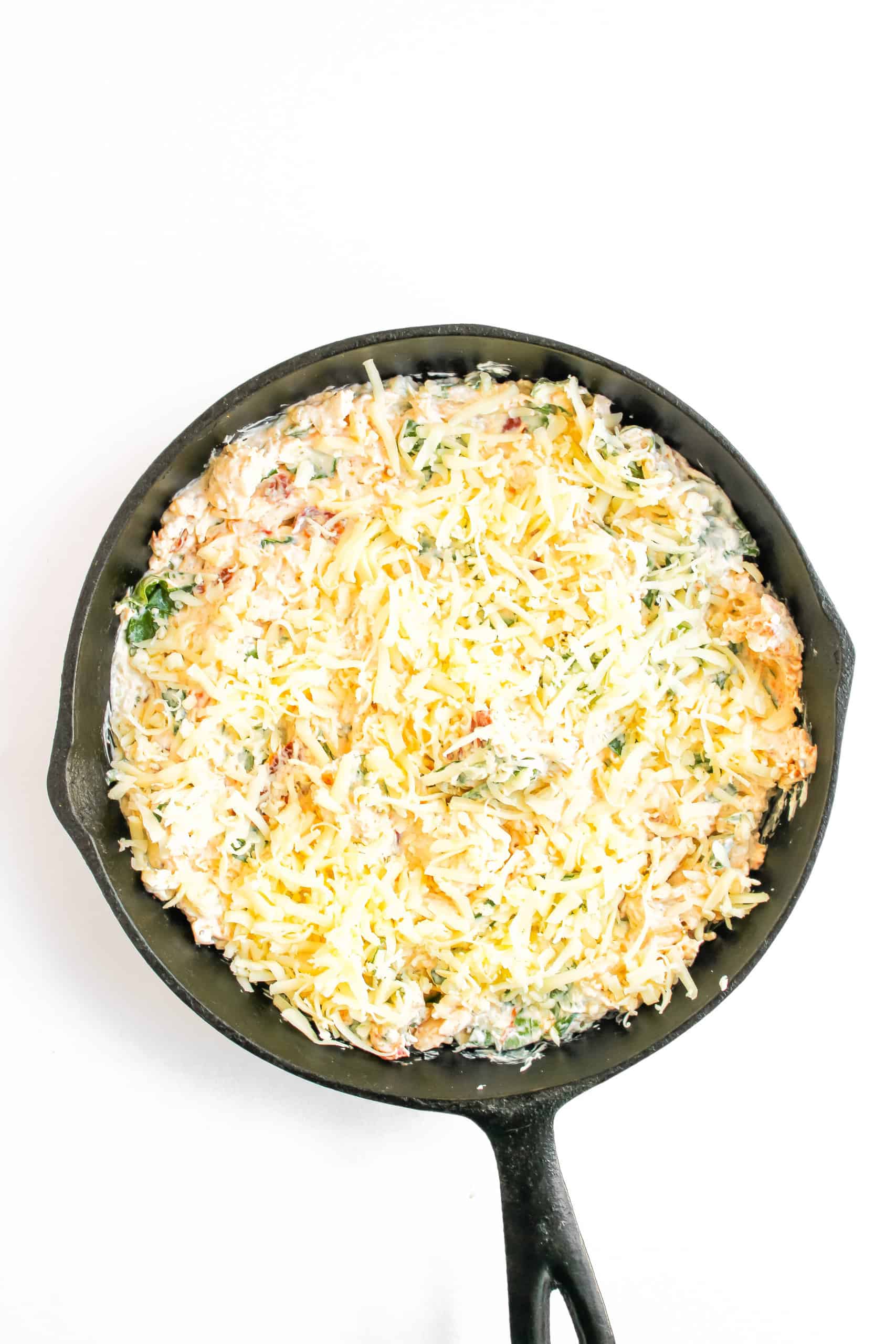 Marry Me Chicken Dip in the skillet topped with mozzarella cheese.