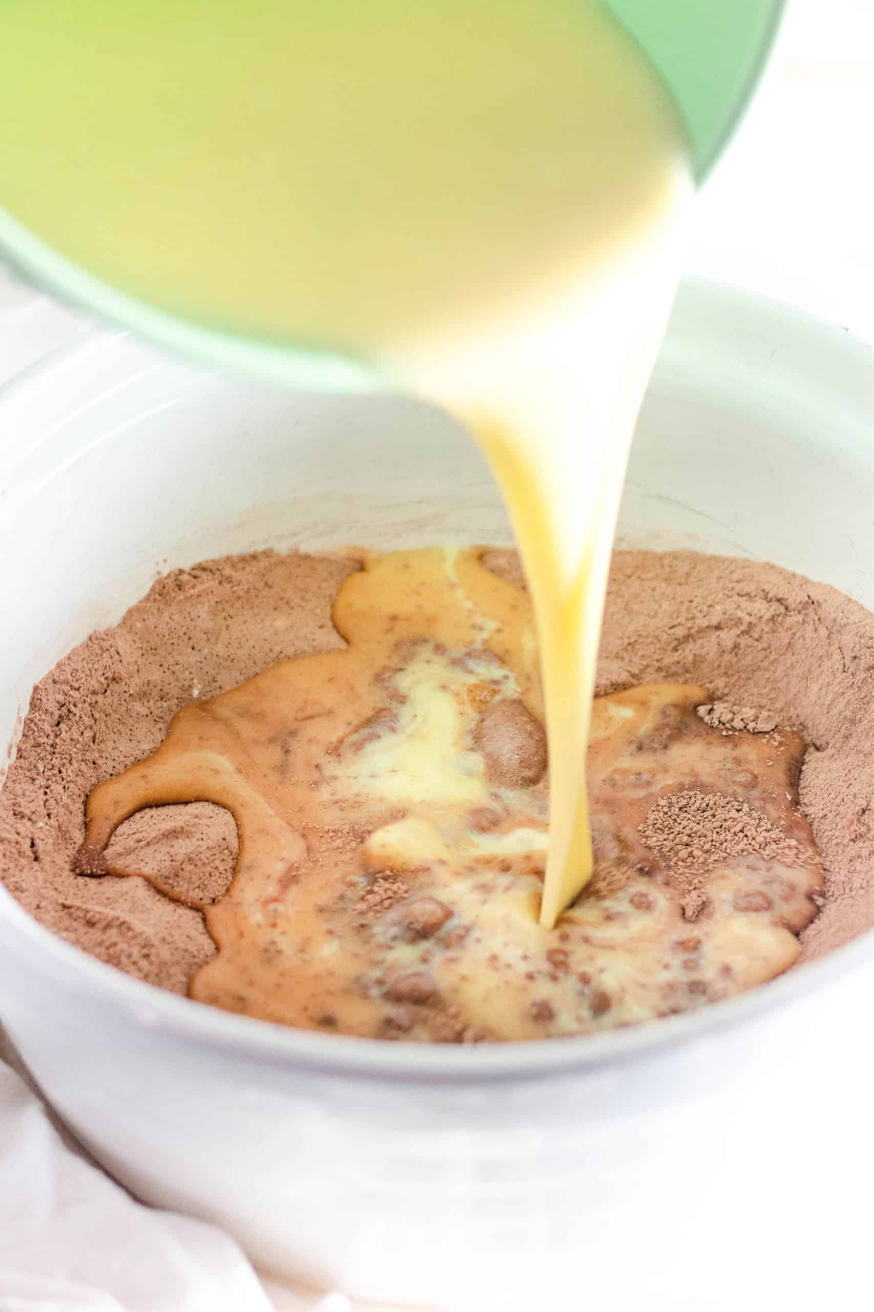 The wet and dry ingredients being combined in a bowl.