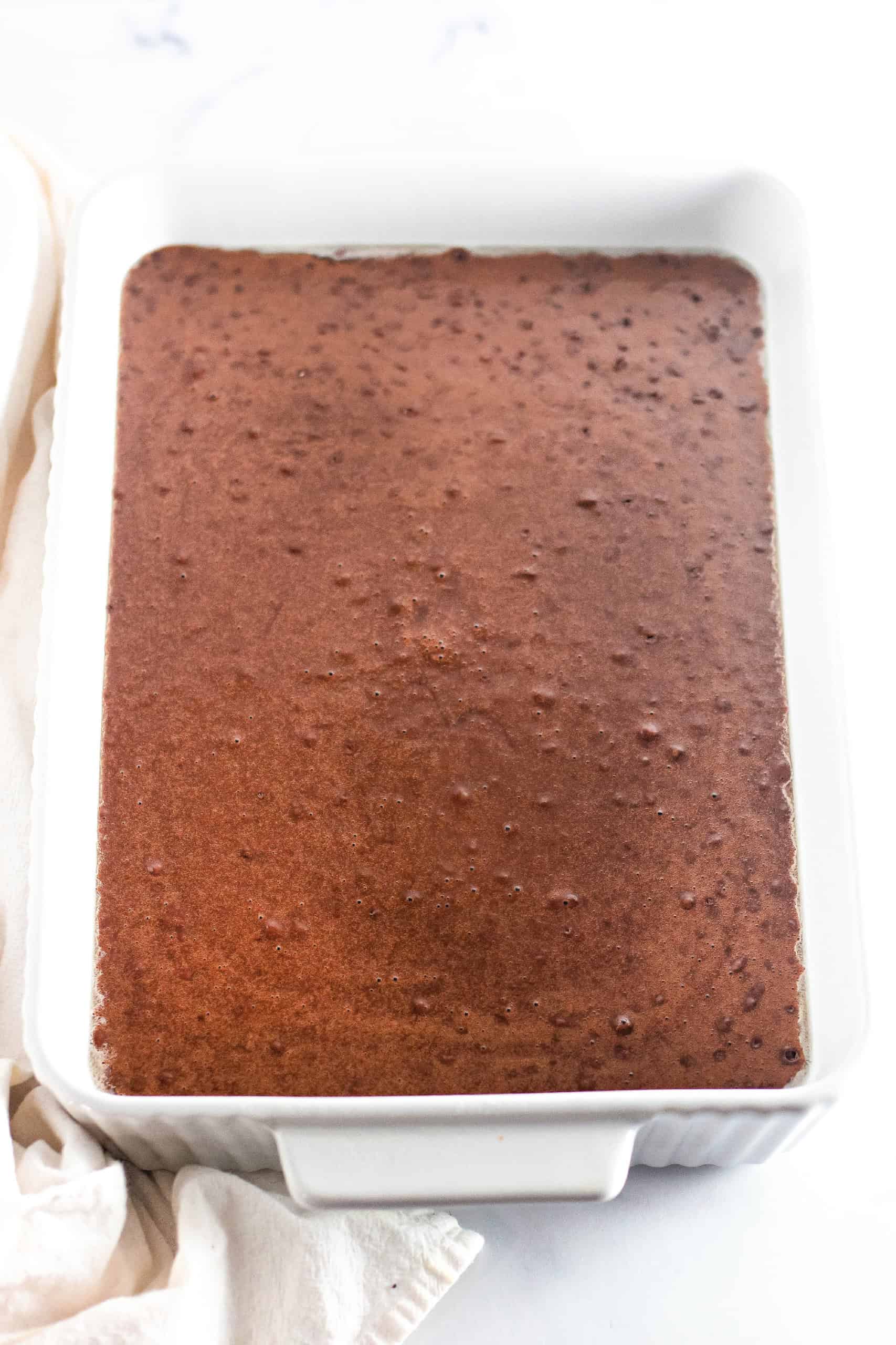 The cake batter poured into a baking pan.