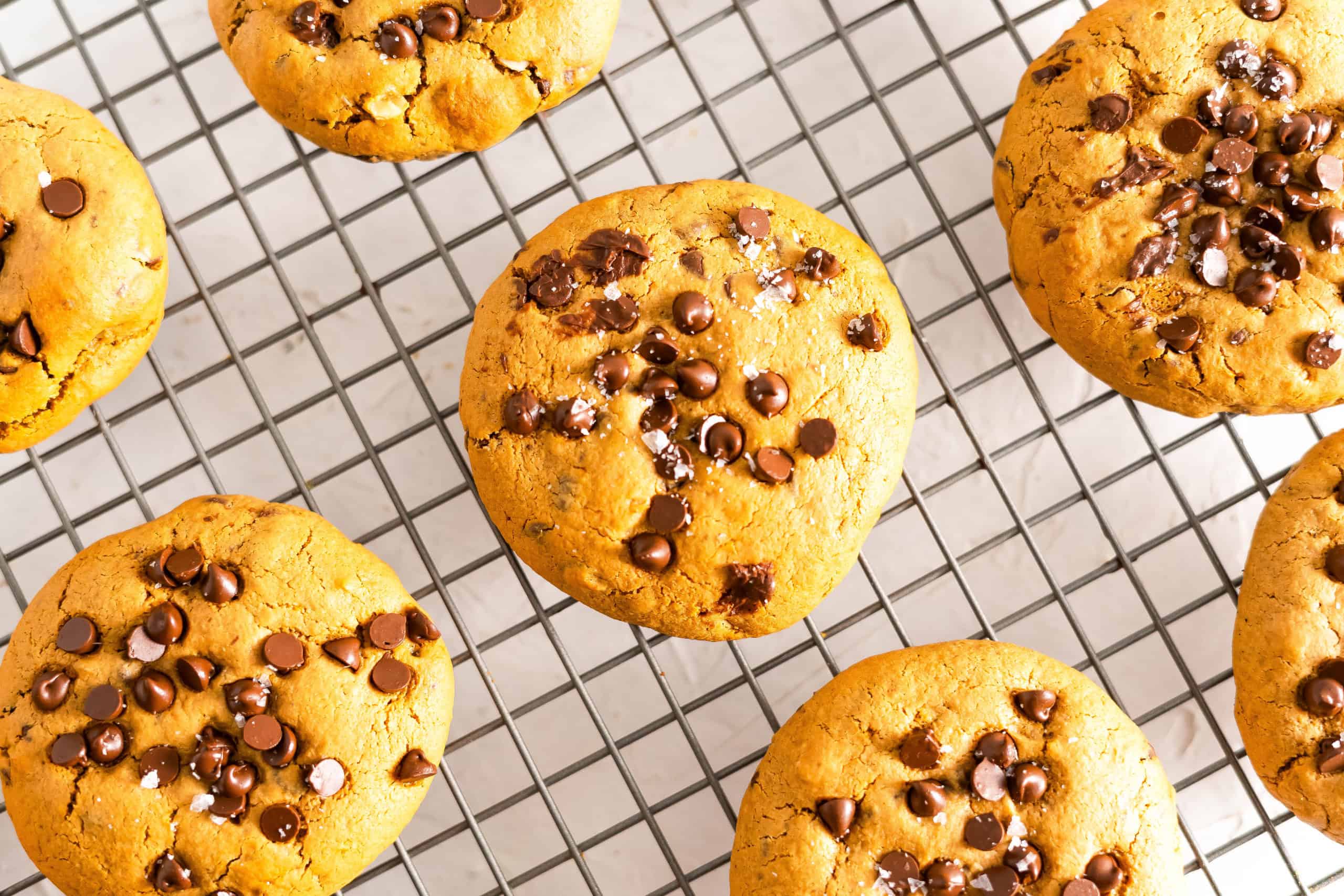 Soft baked gluten free chocolate chips cookies on cooling rack