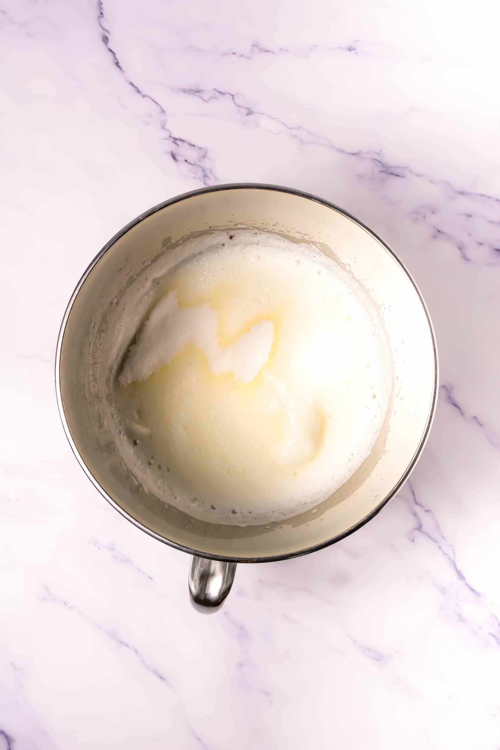Egg whites and sugar whipped in a bowl.