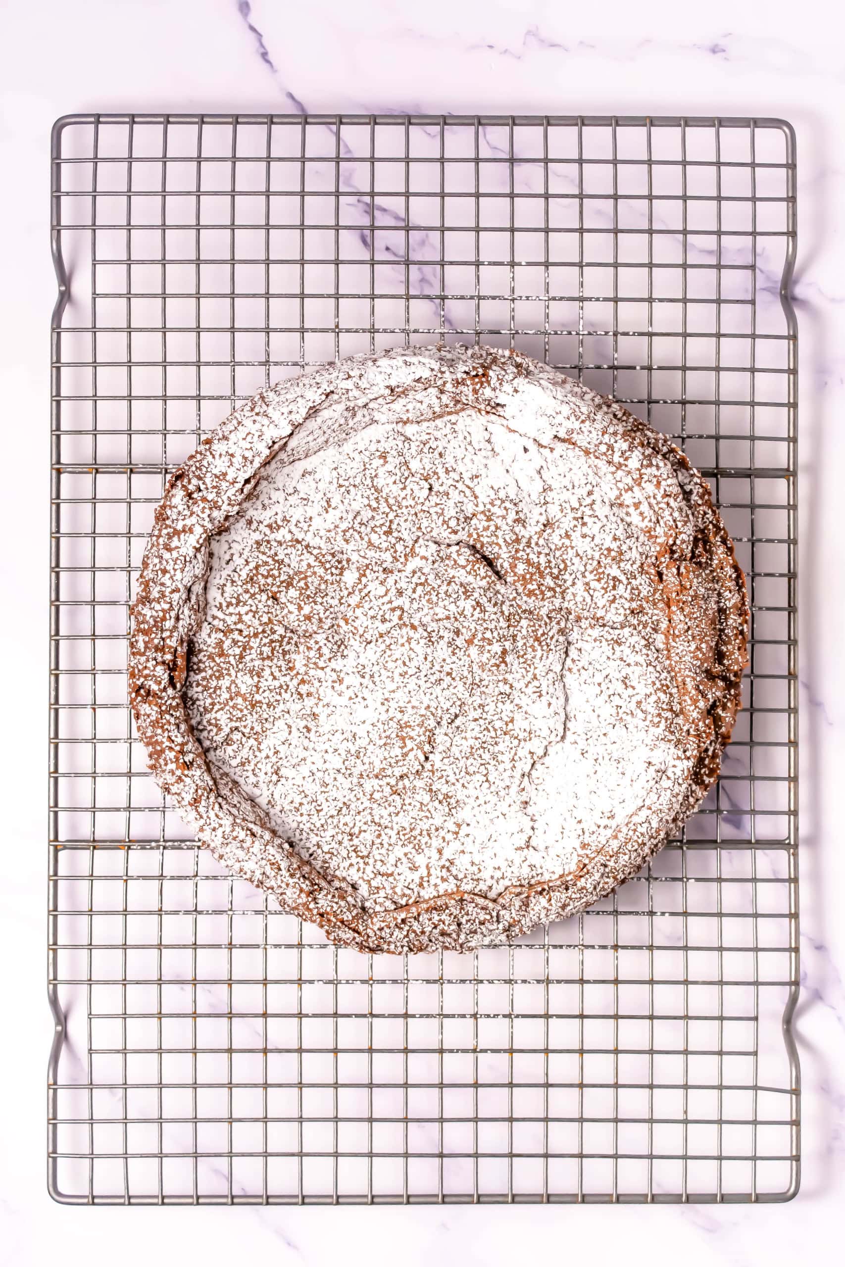 Finished flourless chocolate torte with powdered sugar on top