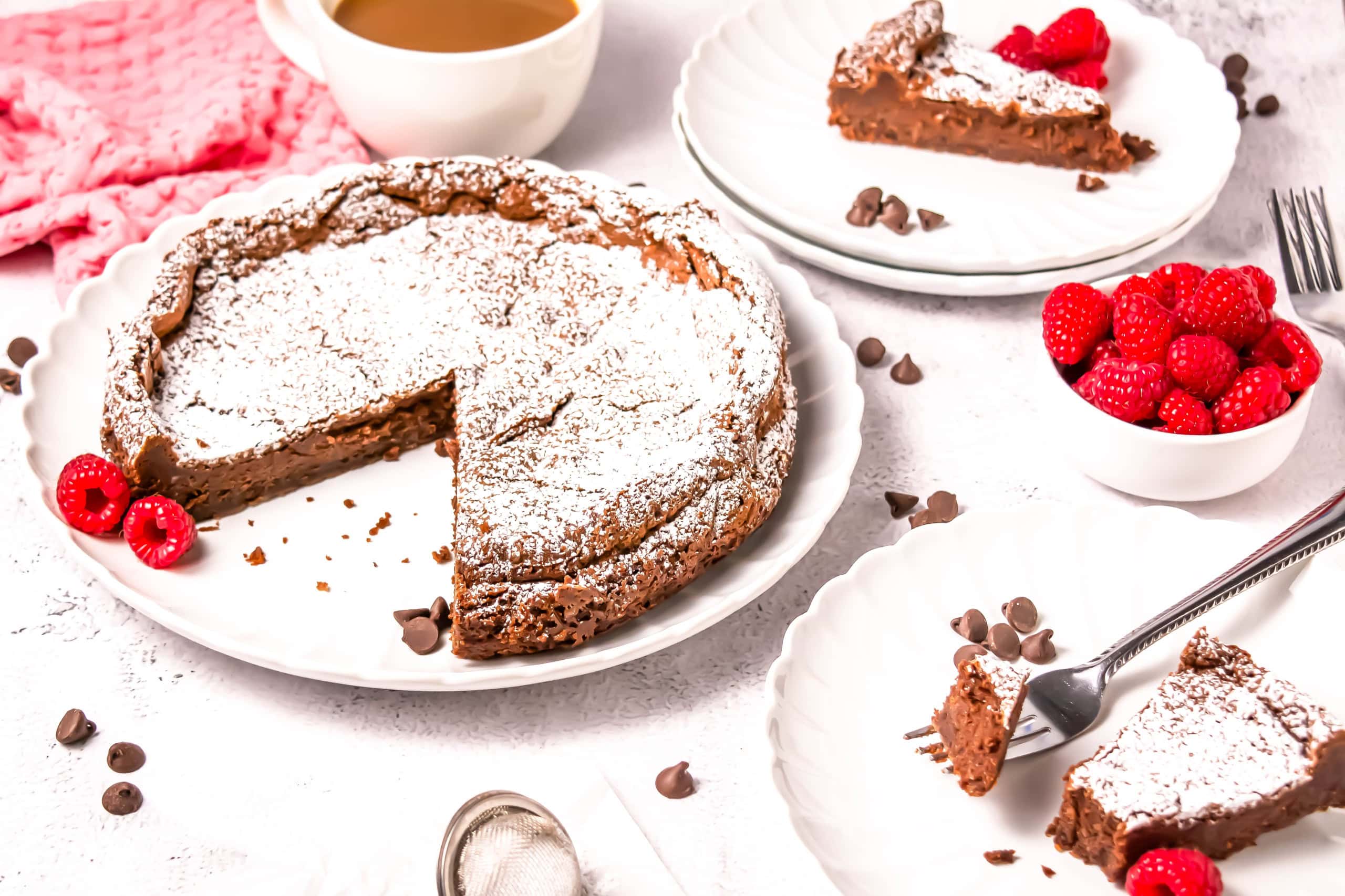 A plate with the chocolate torte with slices on white plates