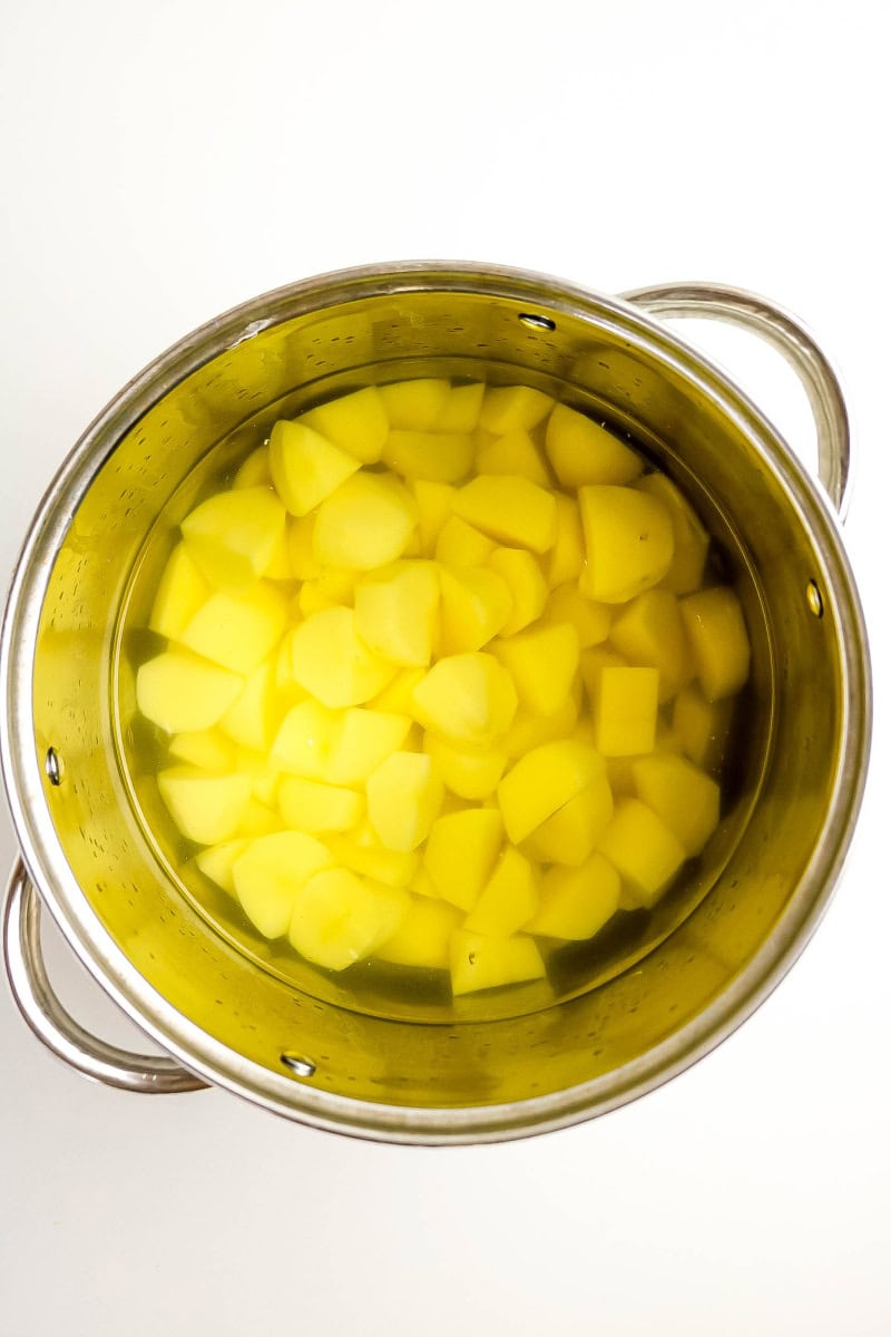 Pot with boiling potatoes