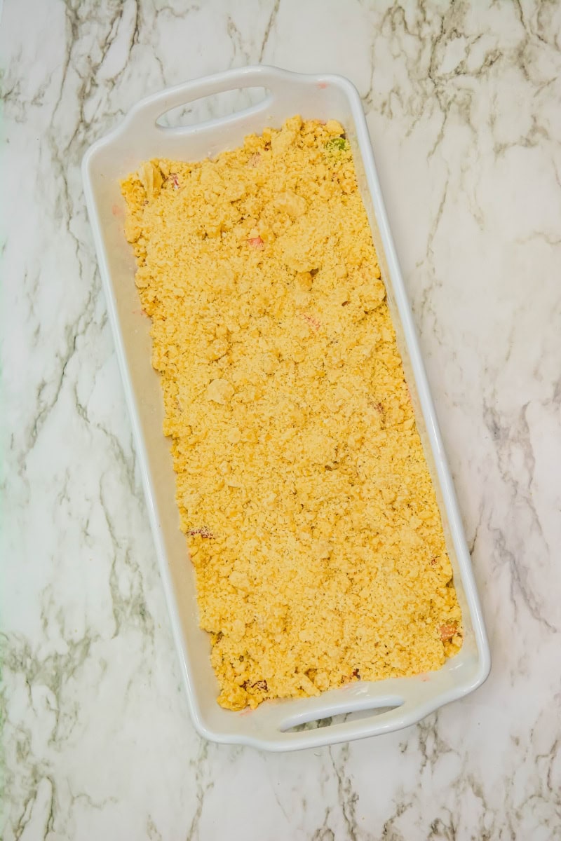 Gluten free strawberry rhubarb crumble in white baking dish.