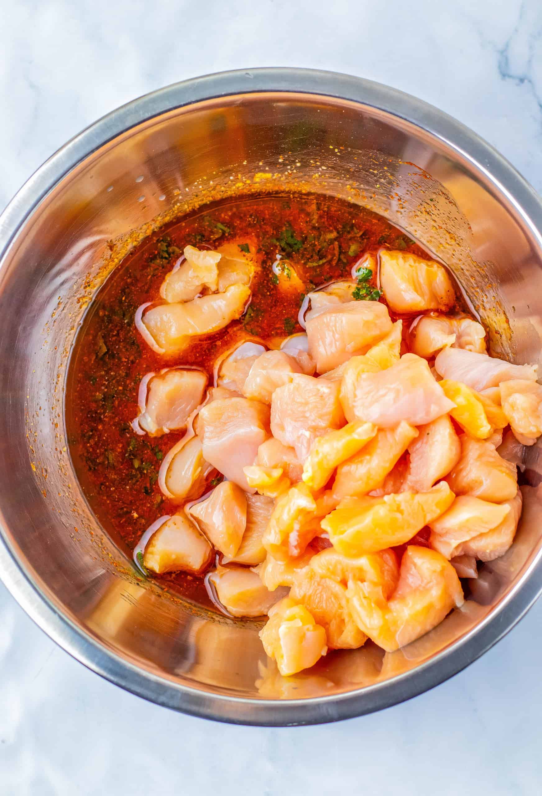 Bowl with marinated chicken and spices