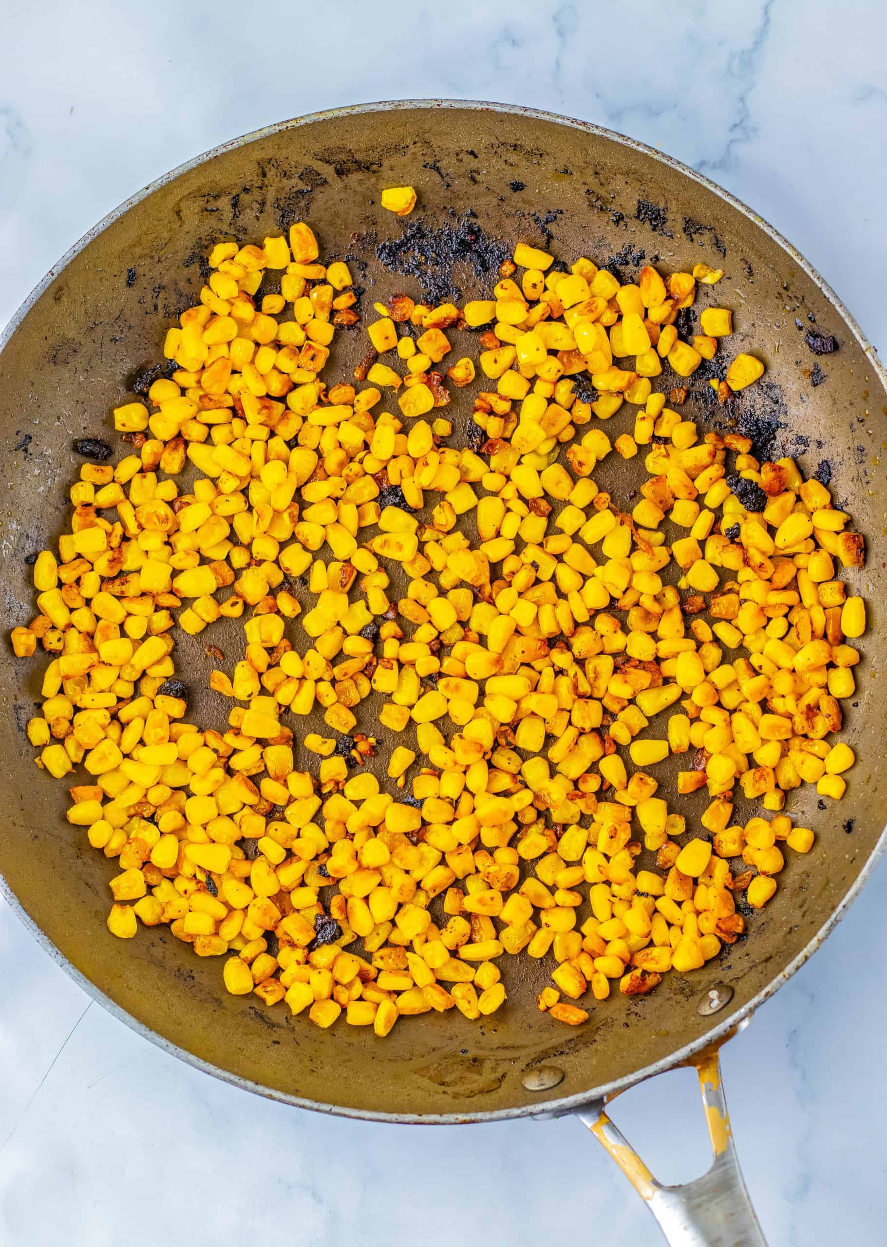 Charred corn in a skillet