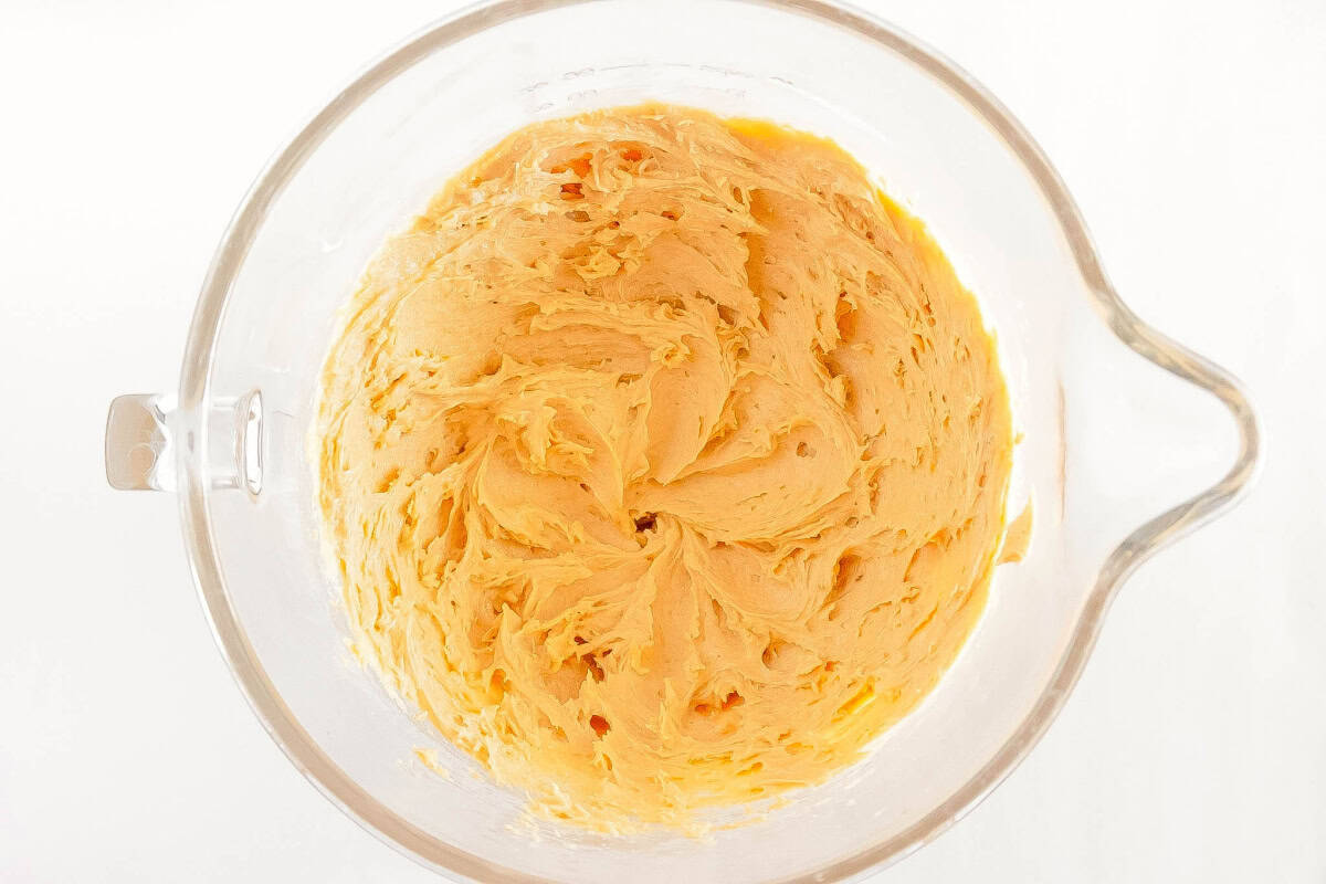 Butter, sugars, peanut butter, eggs and vanilla extract combined until smooth in a glass bowl.