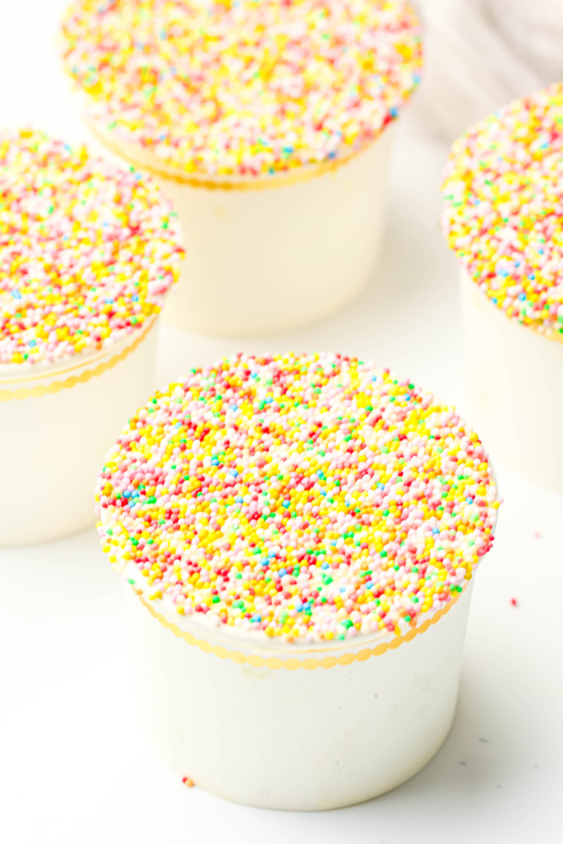 Four dessert cups with the dot cakes in them.