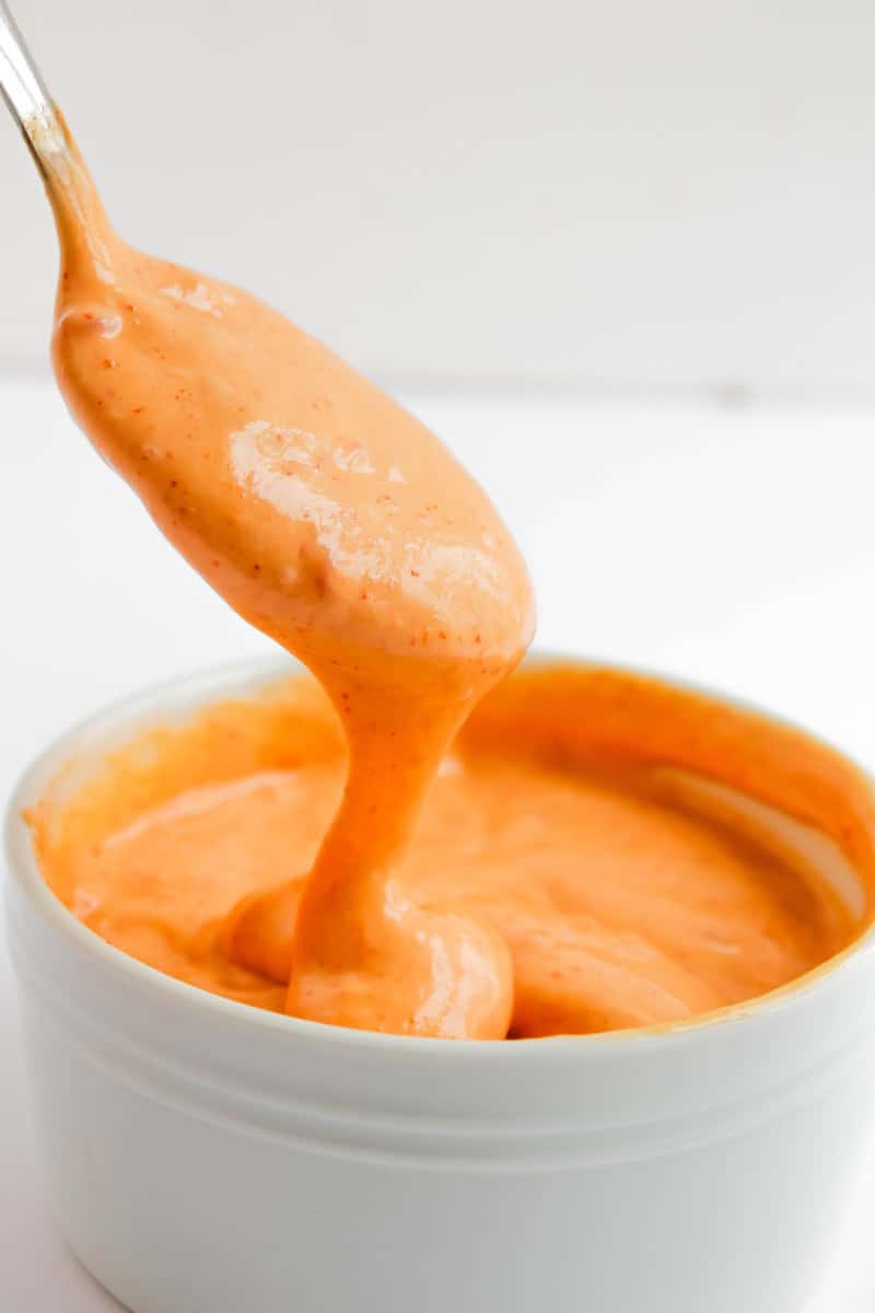 Spoon lifted with bang bang sauce on it