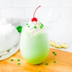 Shamrock shake on a wooden board with a white towel and white background