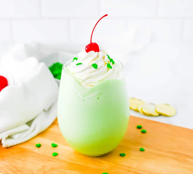 Shamrock shake on a wooden board with a white towel and white background