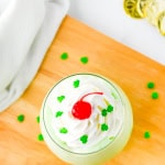 Overhead shot looking down on shamrock shake thats on a wood board