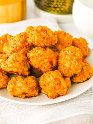 A white plate of stacked Rotel sausage balls