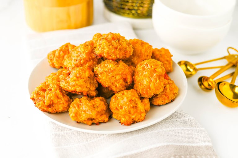A white plate of stacked Rotel sausage balls