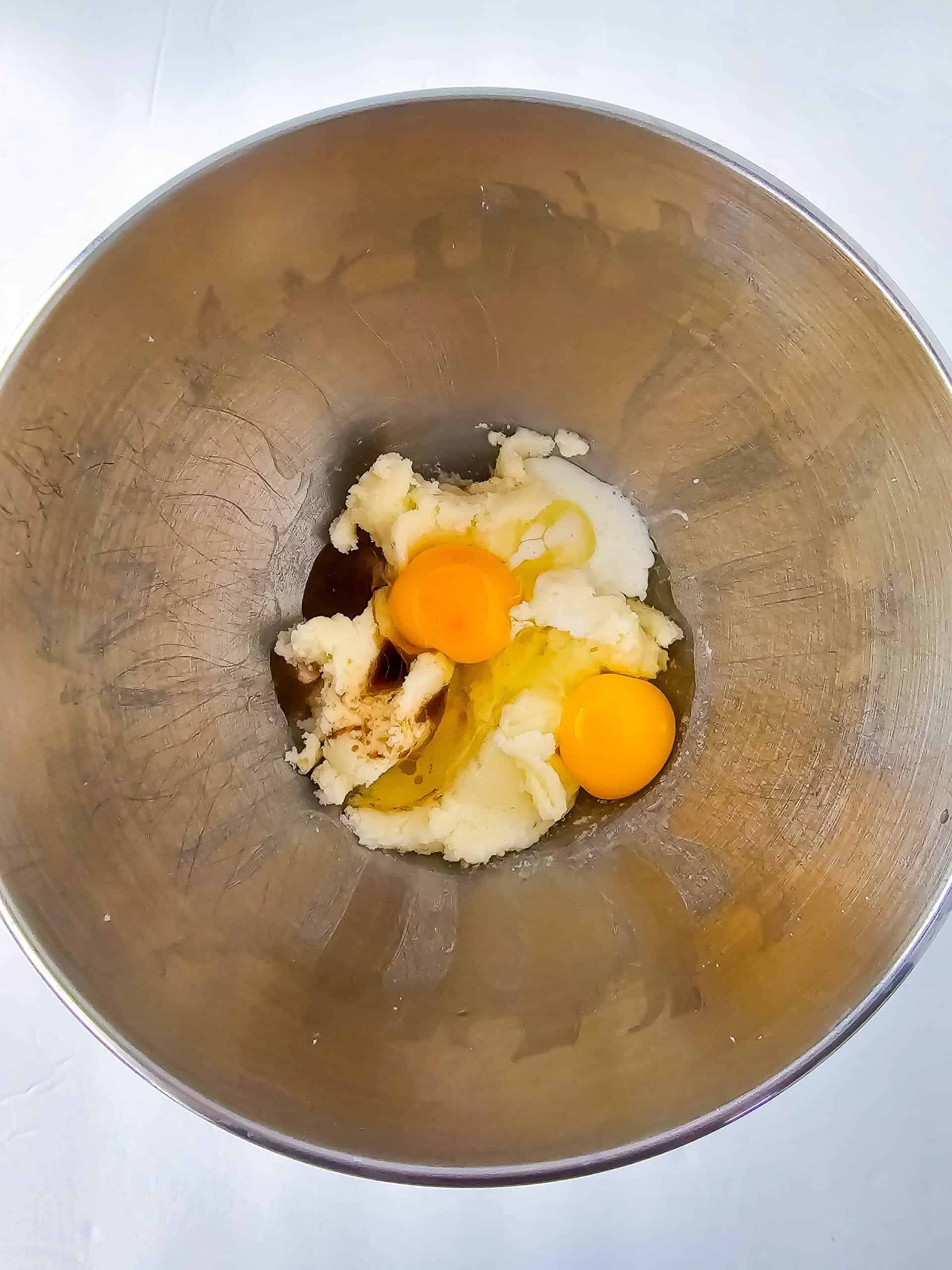 A bowl with the sugar, butter, eggs and vanilla