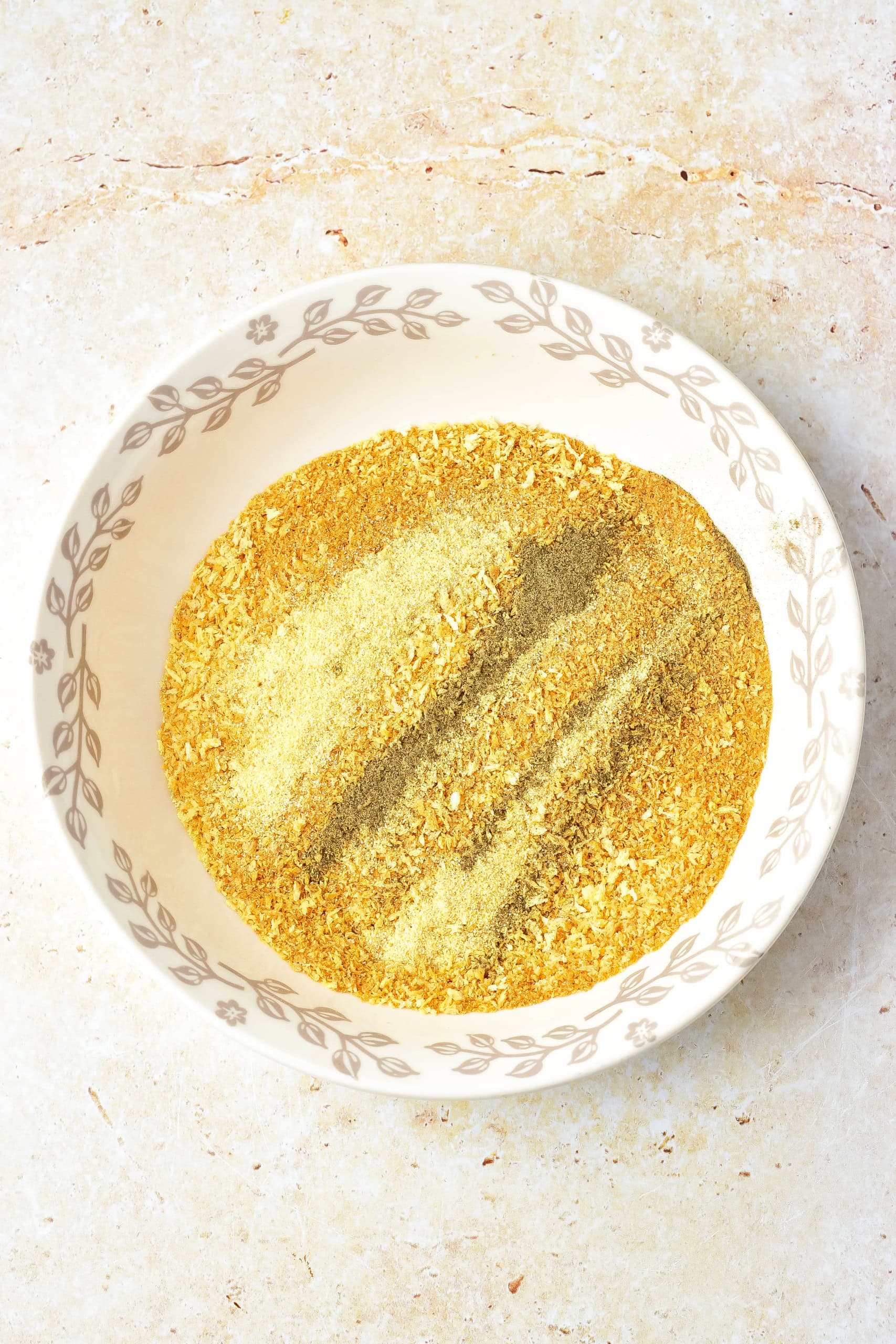 Toasted breadcrumbs and seasoning mixture in one bowl