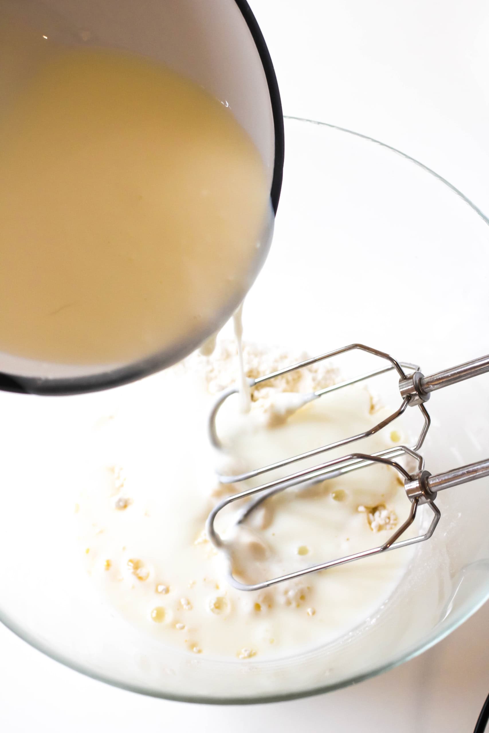 Buttermilk being poured into flour mixture.