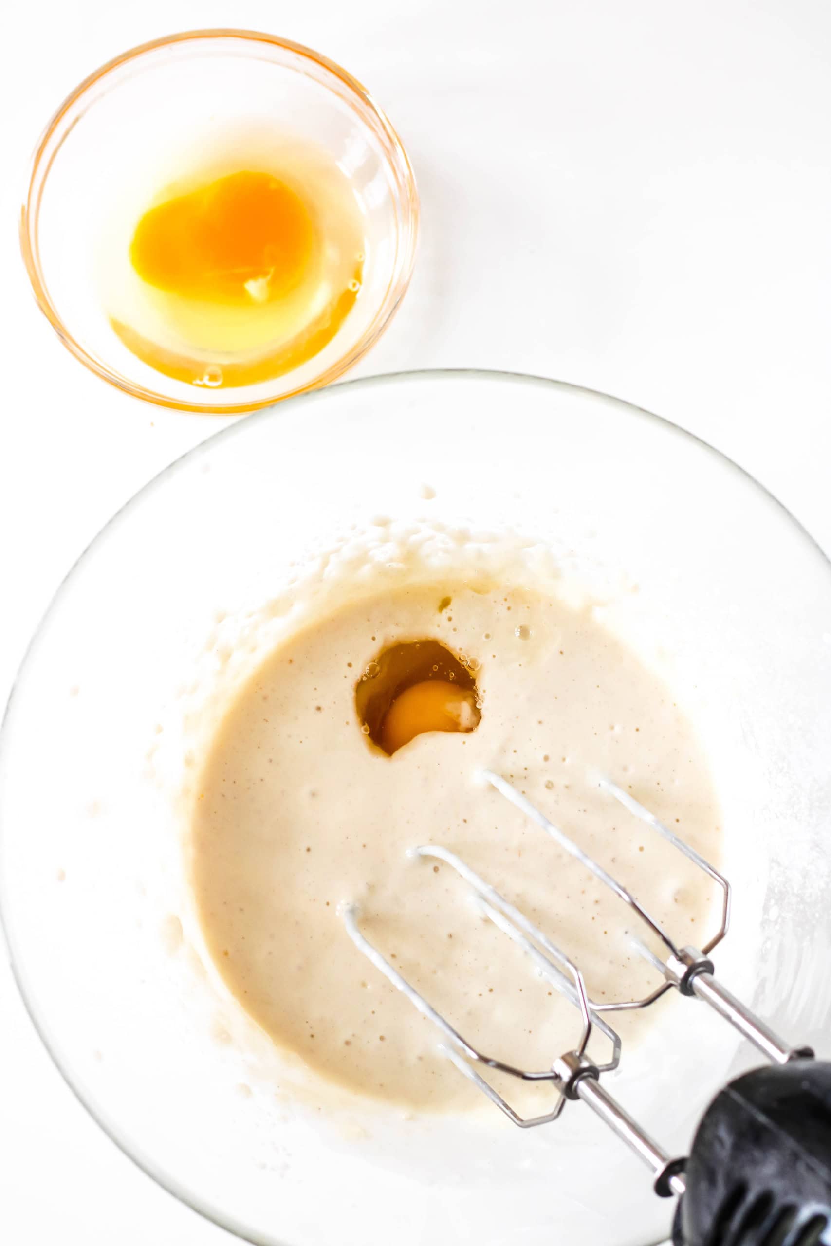 A bowl with flour, salt, buttermilk and one egg.