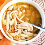 A bowl of gluten free chicken noodle soup in white bowl