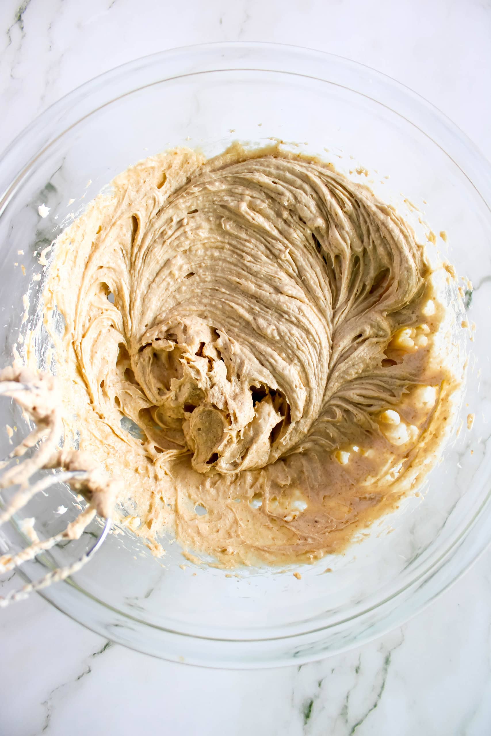 The cane sugar, brown sugar, egg and vanilla whisked together with the creamed cream cheese and butter.