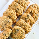 Gluten free oatmeal raisin cookies on a white platter.