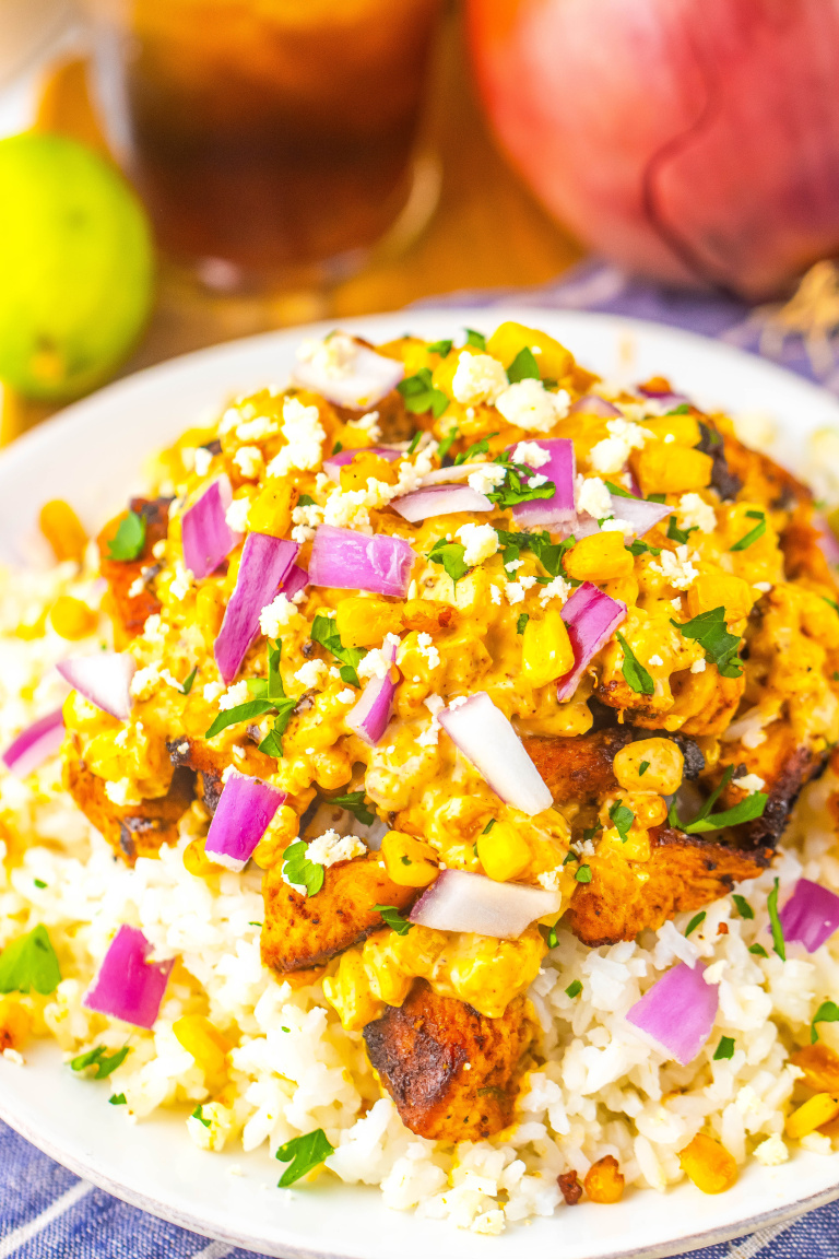 A big white bowl with Mexican street corn chicken and rice.