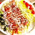 White plate with grinder salad